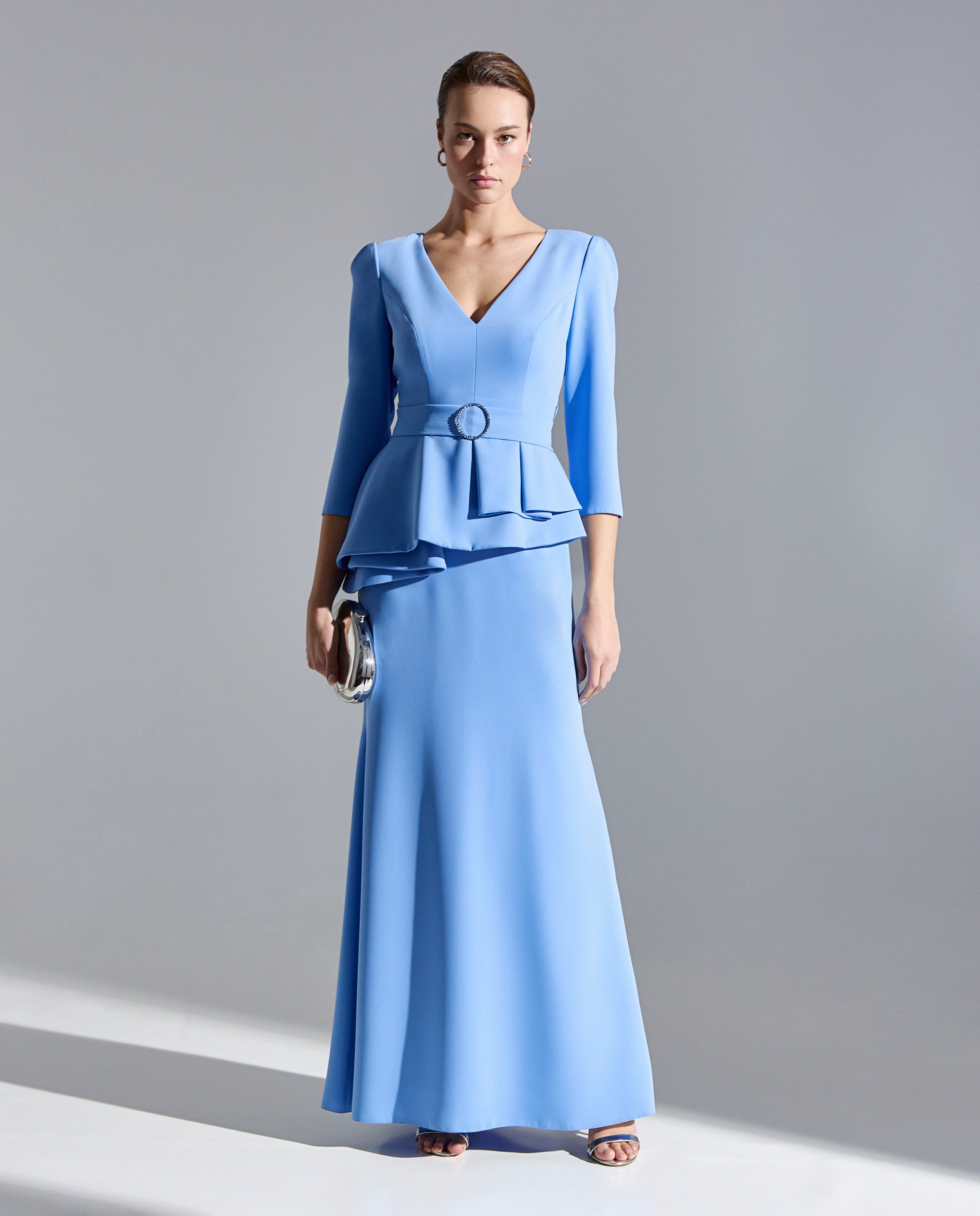 Vestido largo celeste con escote cruzado peplum en la cintura de Sonia Peña